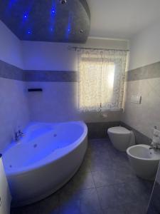 a large bathroom with a large tub and a toilet at Casa Sole in Fenis +10 photos