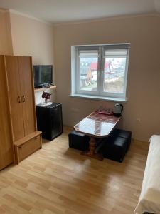 a living room with a table and a window at U Karola in Darłowo