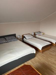 a room with three beds in a room at U Karola in Darłowo