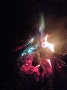 a fire pit in the dark with flames at Raahi Roots in Vashisht