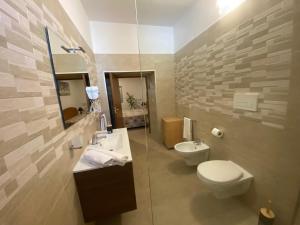 a bathroom with a toilet and a sink at B&B "Sara" in Gemini +35 photos