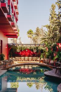a swimming pool with chairs and a bridge at Nobu Hotel Marrakech in Marrakesh