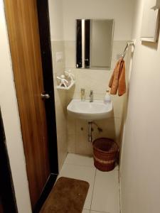 a small bathroom with a sink and a mirror at MaEra's Den in Hinjewadi +3 photos