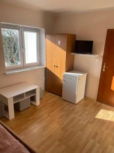 a small kitchen with a desk and a refrigerator at U Karola in Darłowo +15 photos