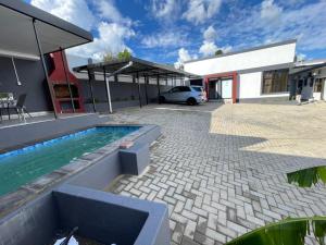 a house with a swimming pool in a yard at Premium View Guesthouse in Windhoek
