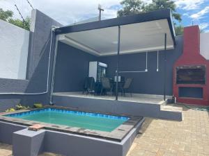 a house with a swimming pool in the backyard at Premium View Guesthouse in Windhoek