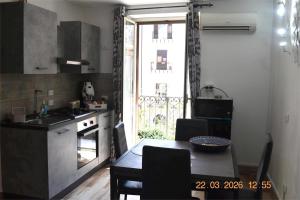 a kitchen with a table and a kitchen with a window at Loft le Due Effe al Capo in Palermo