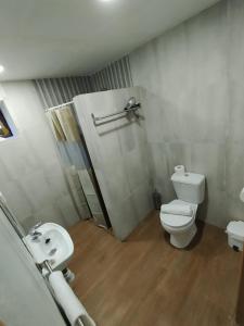 a white bathroom with a toilet and a sink at refuxio de pambre in Palas de Rei