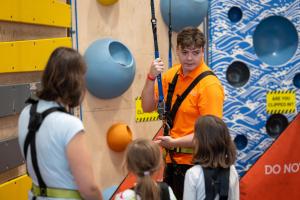 a man teaching a group of children on a climbing wall at Adventure Parc in Dolgarrog +38 photos
