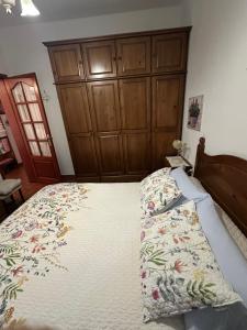 a bedroom with a bed with a wooden headboard at Tijarafe 2 in Tijarafe +48 photos