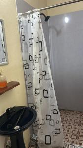 a shower curtain in a bathroom with a toilet at Habitaciones Lala in Las Peñitas