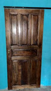 an old wooden door in a room at Habitaciones Lala in Las Peñitas +4 photos