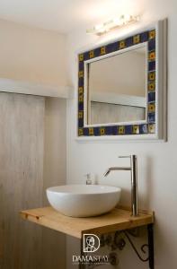 a bathroom with a sink and a mirror at Trulli di Ivana in Ostuni +63 photos