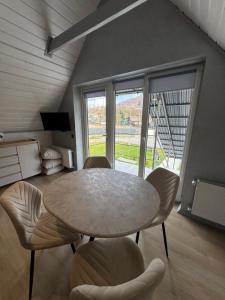 a dining room with a circular table and chairs at Вича апартаменти in Sasivka