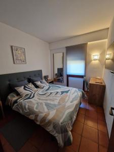 a bedroom with a bed with a camouflage blanket at Varinos House Praia in Alvor +13 photos
