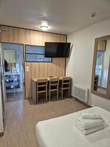 a hotel room with a bed and a television on a wall at Class'eco Charleroi in Charleroi