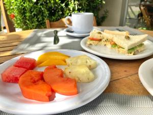 a table with two white plates of food on it at Pousada Porto Rio in Parnaíba +15 photos
