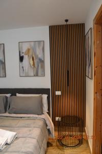 a bedroom with a bed and a wooden door at Loft le Due Effe al Capo in Palermo