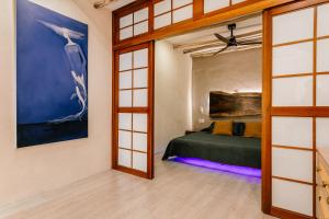 a bedroom with a bed and a large window at Casa Rocka Boutique Breakfast & Beach Club included in Isla Mujeres +70 photos