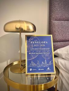 a sign on a glass table with a lamp at Red Roof Apartments Old Town in Krakow