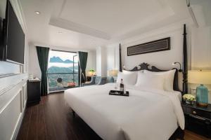 a bedroom with a large white bed and a window at Hotel Del Couple Sapa in Sapa