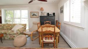 a living room with a table and chairs and a couch at Dunescape in West Cape May