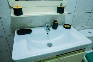 a bathroom sink with two candles on top of it at Suite Kimia - Chic T2, Rue Des Jardins, Cocody, Vallon, Abidjan in Abidjan +10 photos