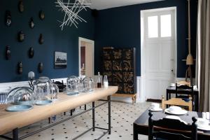 
a room with a table and chairs in it at Chateau De La Resle - Design Hotels in Montigny-la-Resle
