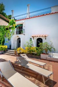 a group of chairs sitting outside of a building at Villa Lyla in Capri
