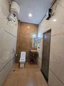 a bathroom with a toilet and a sink at prabh aasra in Ayodhya +15 photos