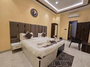a bedroom with a large bed with a large headboard at prabh aasra in Ayodhya