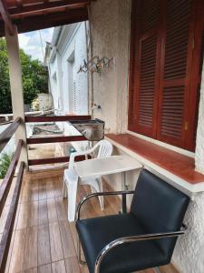 a balcony with a table and chairs on a porch at Pousada Seu Jorge in Campinas