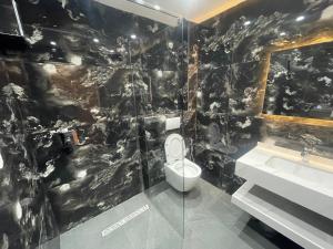 a bathroom with a toilet and a sink at Sea Gate Apartments in Sarandë +183 photos