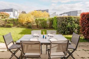 a table with chairs and wine glasses on it at Le repere du golfe in Vannes +3 photos