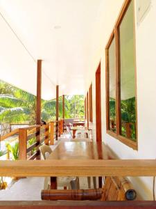 a room with tables and chairs on a balcony at Gregorio's Inn in San Vicente