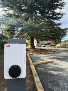 a phone sitting on the side of a road next to a tree at Sans Souci Bed and Breakfast with Luxe Heated Pool in Luzillé