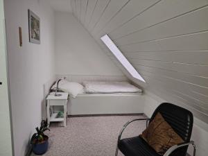 a small room with a bed in a attic at Ferienhaus "Harzblick" in Halberstadt