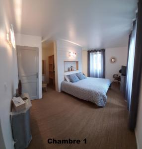 a bedroom with a bed and a window at La Maison d'eglantine in Marnaves