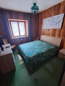 a bedroom with a bed in a room with wooden walls at Terminillo Lo chalet in Terminillo