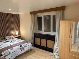 a bedroom with a large bed and a window at StaxBnB in London