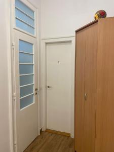 an empty room with a door and a window at Rozelor Double Room in Timişoara