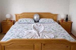 a bed with two white towels on it at Kuća za odmor Petra in Erdut +6 photos
