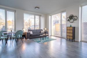 a living room with a couch and a table and chairs at Apartmán Nová Dragounská in Klatovy