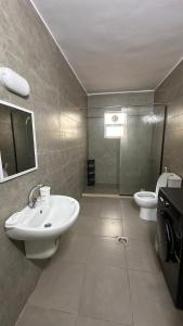 a bathroom with a sink and a toilet at Local apartment in Irbid