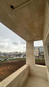 a view from the inside of a building with a window at Local apartment in Irbid