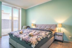 a bedroom with a bed and a large window at Apartmán Nová Dragounská in Klatovy