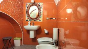 an orange bathroom with a toilet and a sink at La Gemma Amalfitana in Vietri sul Mare +66 photos