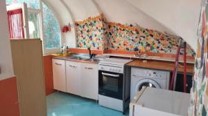 a kitchen with a sink and a washing machine at La Gemma Amalfitana in Vietri sul Mare