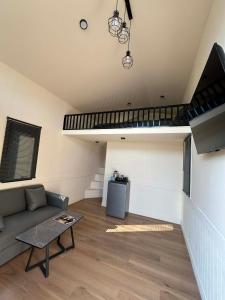 a living room with a couch and a staircase at Baan Noah บ้านโนอาห์ in Lop Buri +7 photos