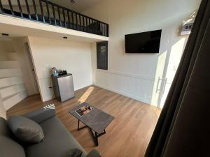 a living room with a couch and a tv at Baan Noah บ้านโนอาห์ in Lop Buri